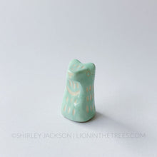 Small sgraffito bear totem done with pastel teal underglaze and finished with clear glaze.