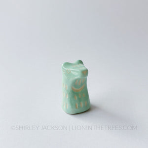 Small sgraffito bear totem done with pastel teal underglaze and finished with clear glaze.