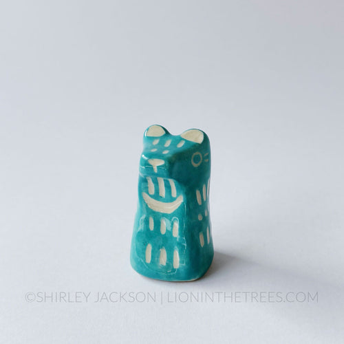 Small sgraffito bear totem done with turquoise underglaze and finished with clear glaze.